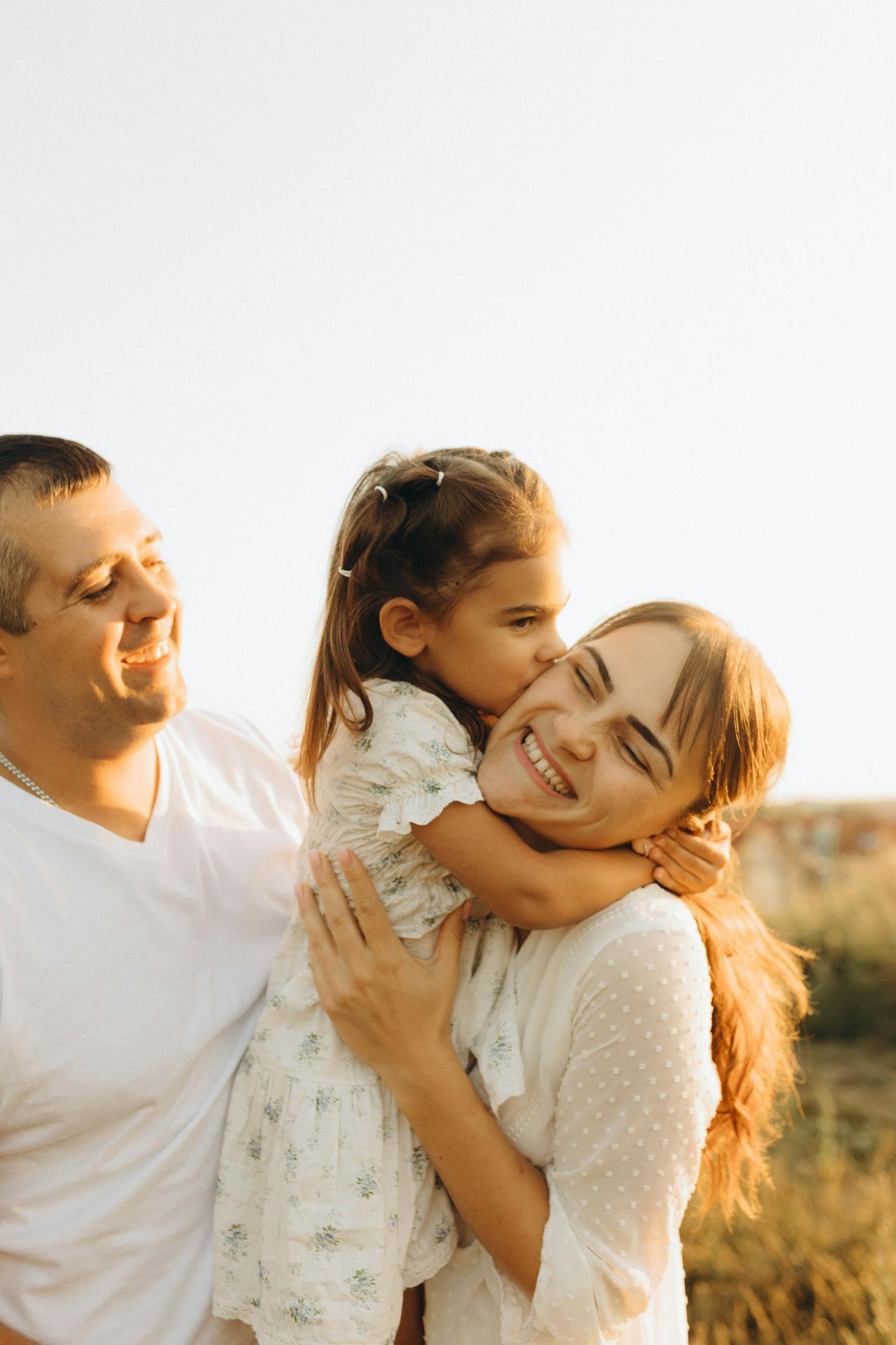 A parent and child smiling together